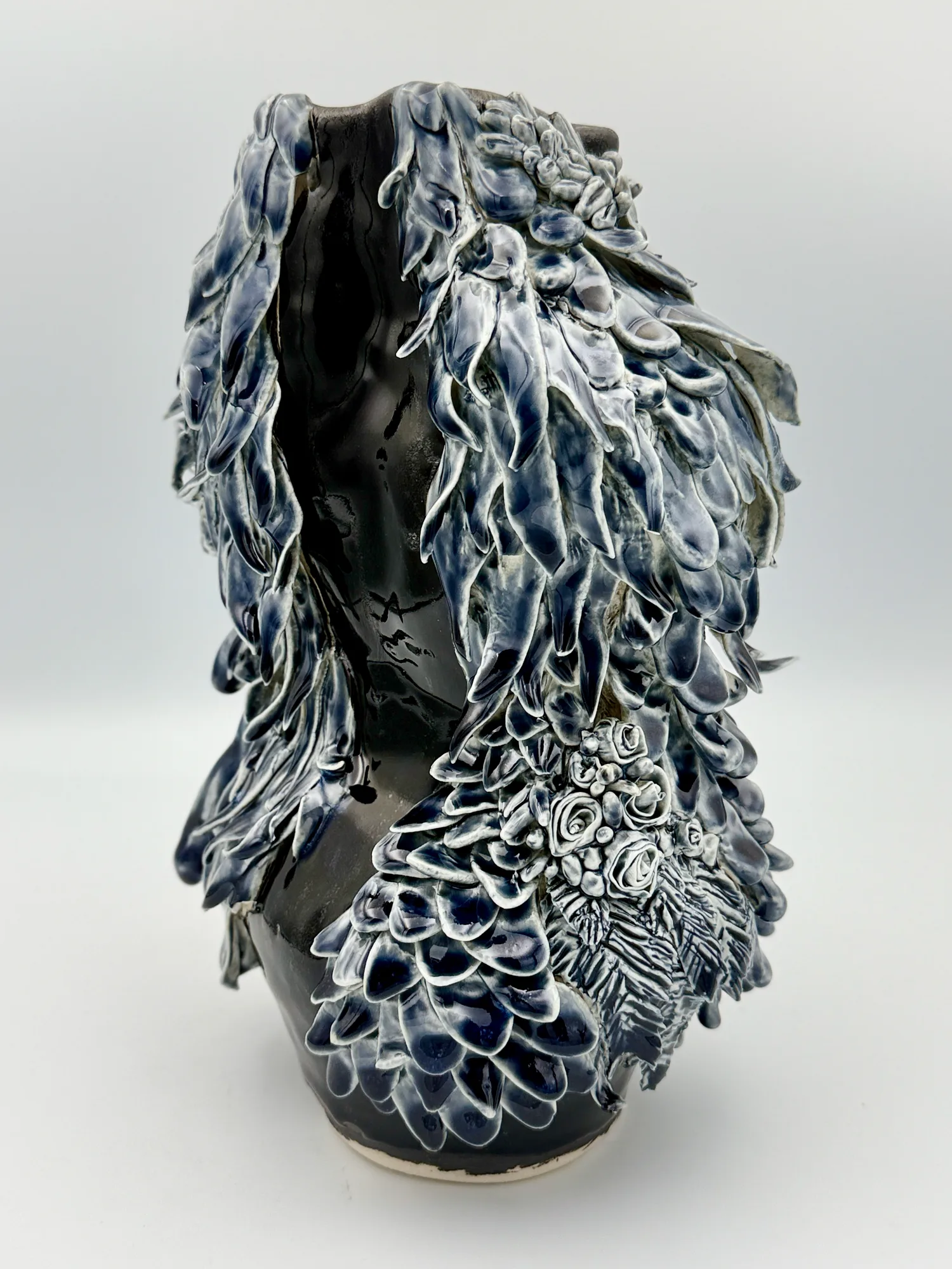 A blue and white sculpture covered in dense ruffled texture
